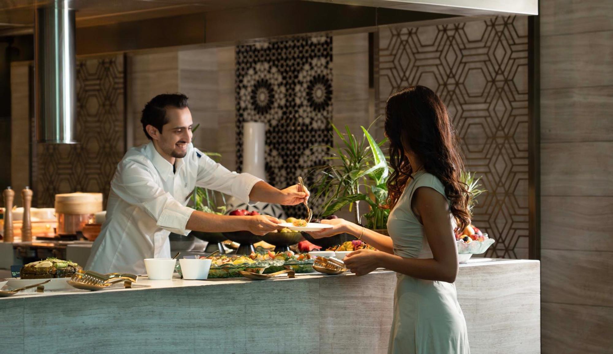Fairmont Riyadh Luaran gambar A chef serving a guest at the buffet